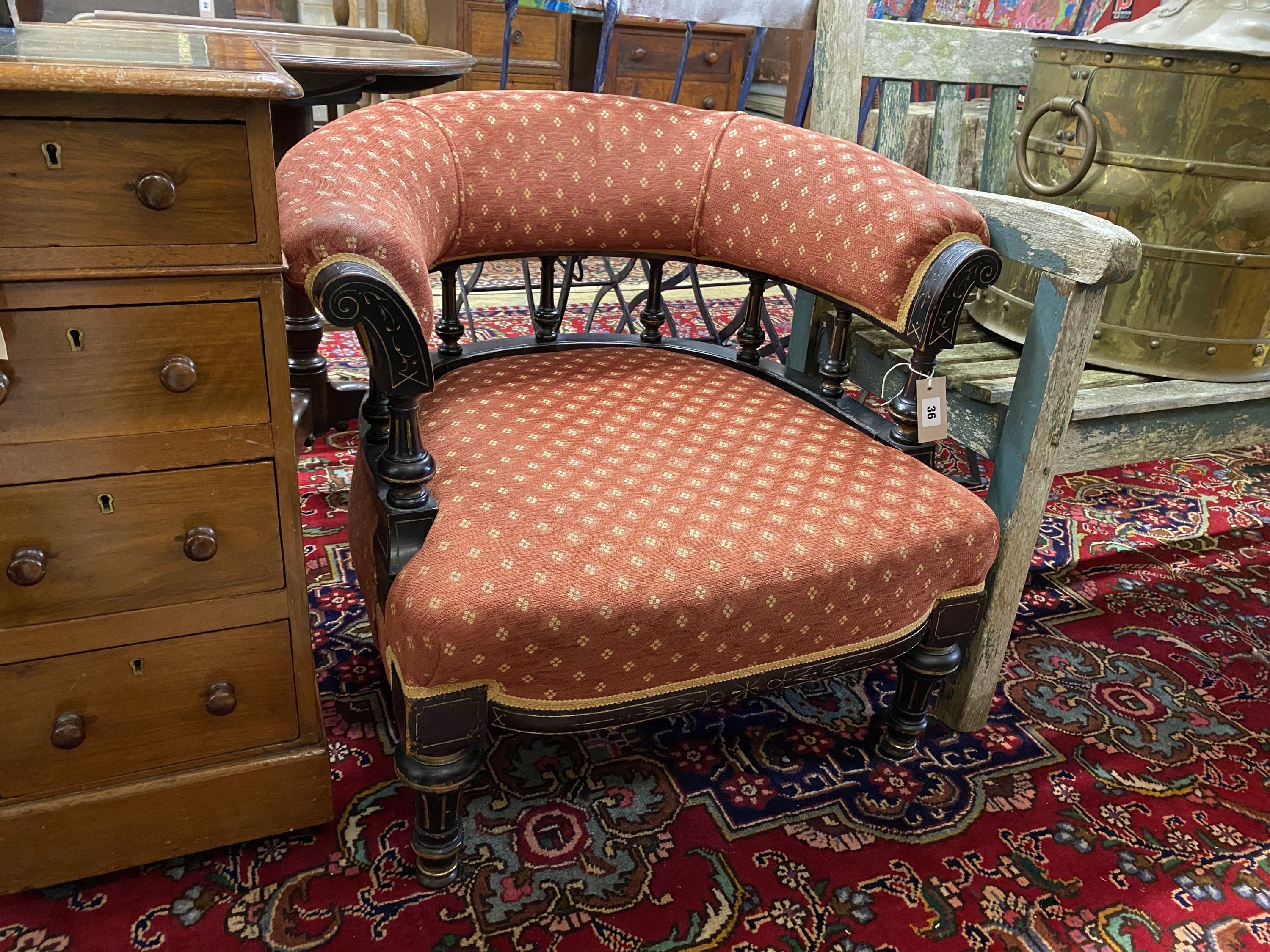 A late Victorian aesthetic movement ebonised tub framed chair, width 72cm, depth 64cm, height 66cm